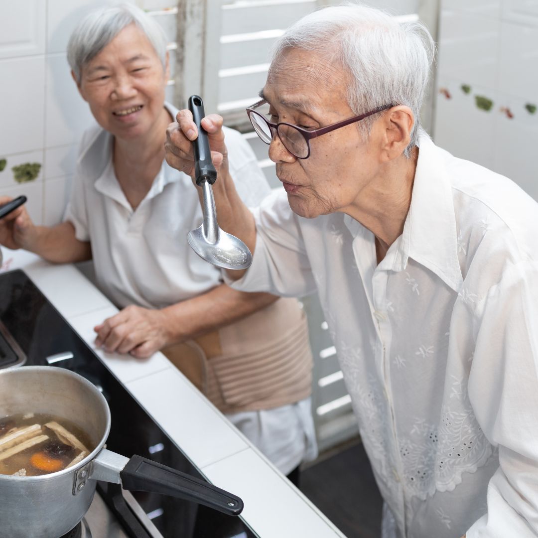 Asian seniors cooking a meal together